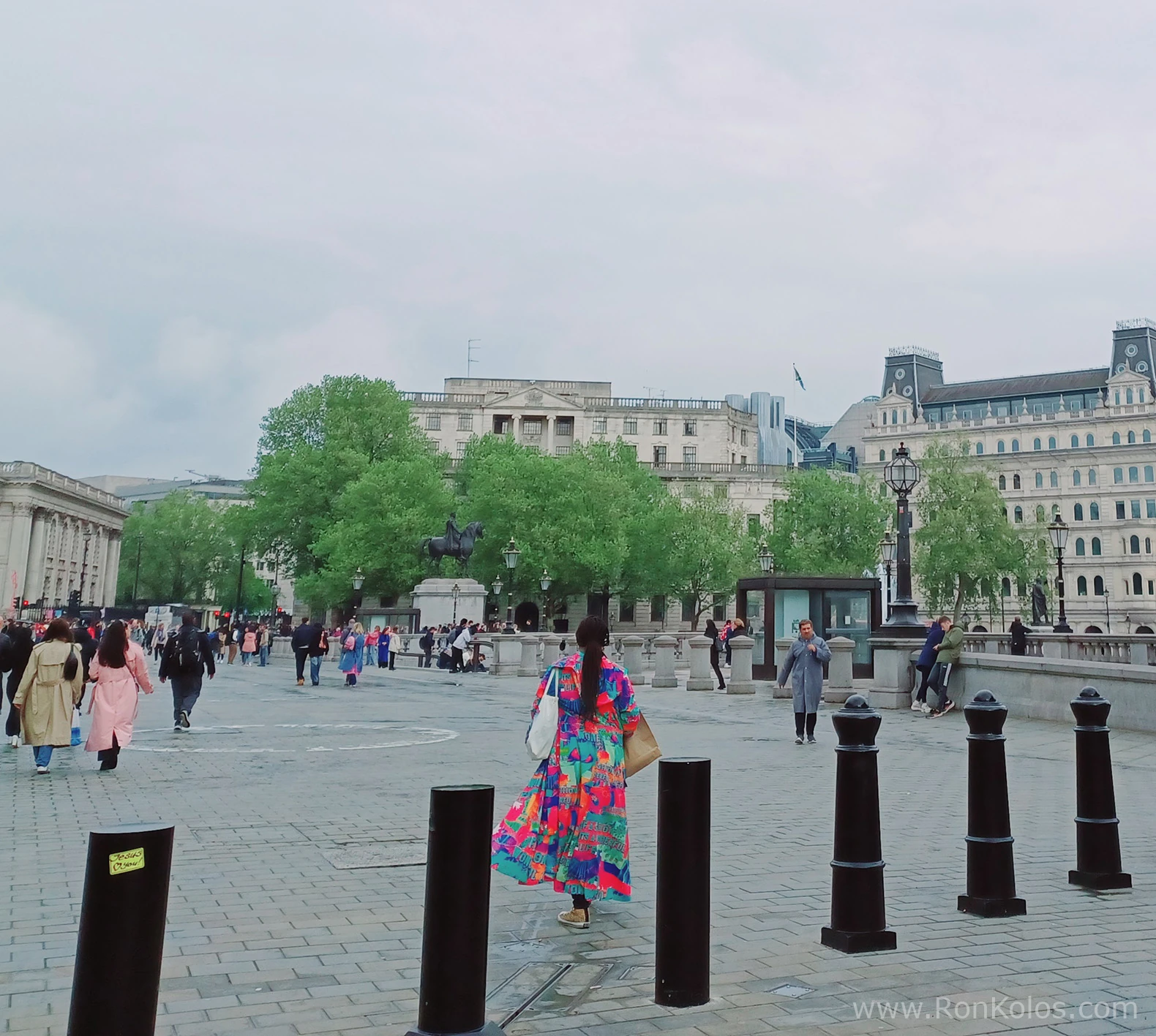 Colorfully dressed woman walking away from camera