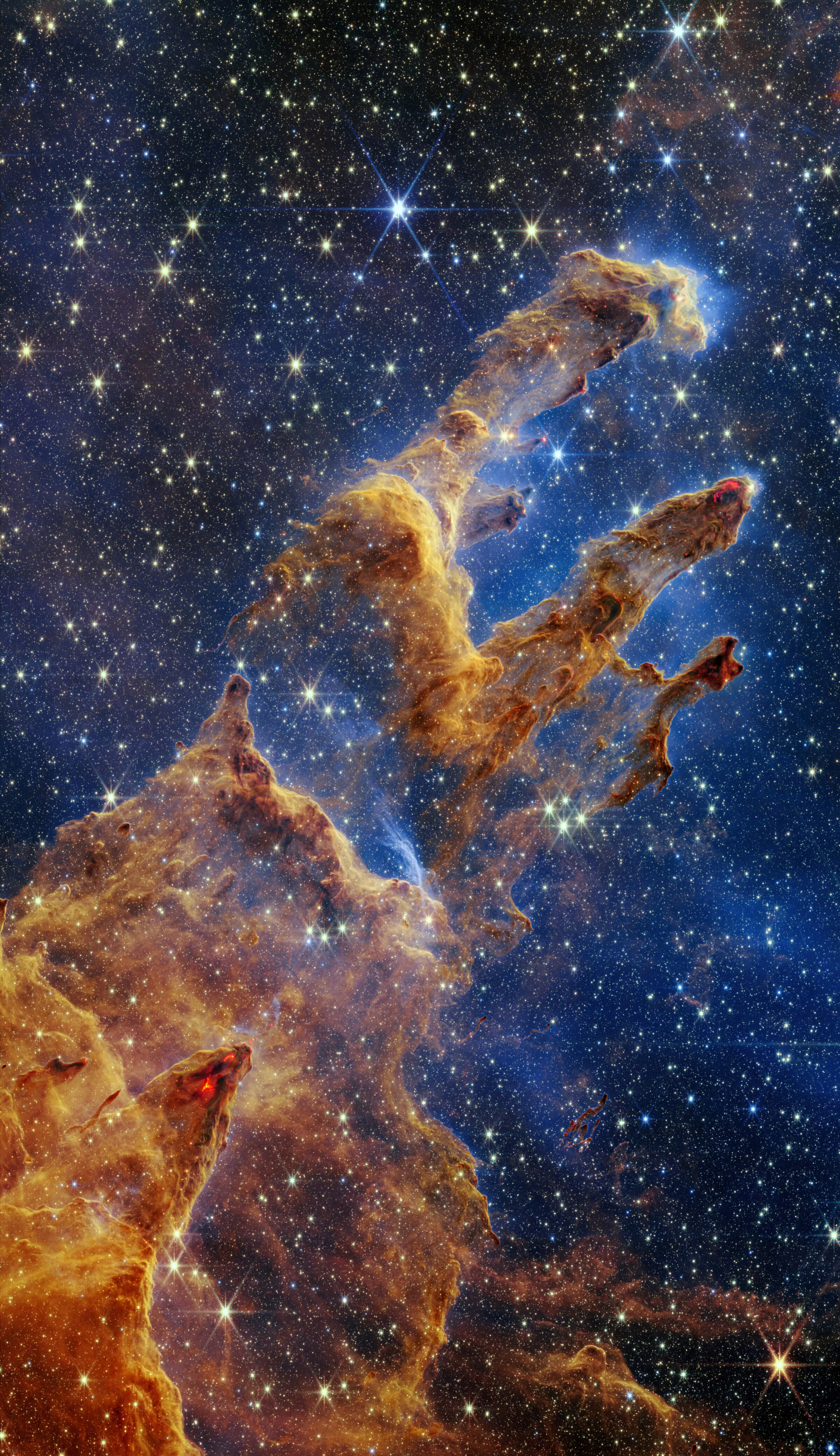 Image shows the Pillars of Creation. It looks like pillars of gas, glowing with stars. They look like some kind of ghosts or spirits.