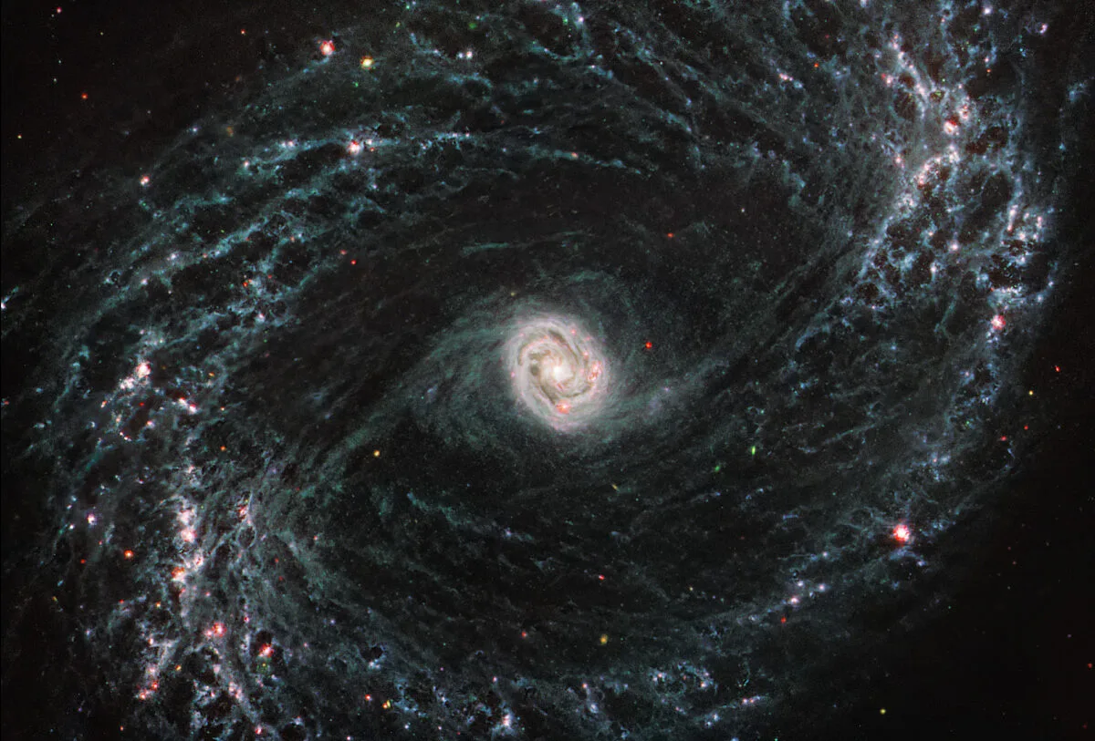 Image shows a galaxy in the shape of a twister like as if you are looking into a storm from above.
