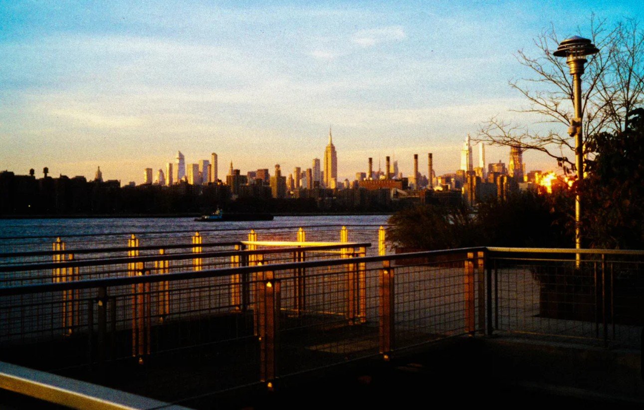 Photograph of central park. The photo overlooks the lake and the iconic buildings surrounding the park.